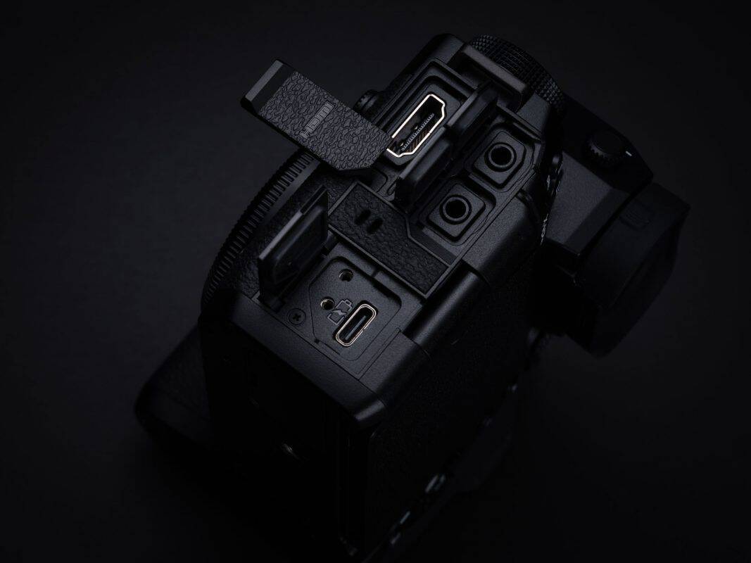 Professionelle DSLR-Kamera mit offenem Speicherfach und SD-Kartensteckplatz.